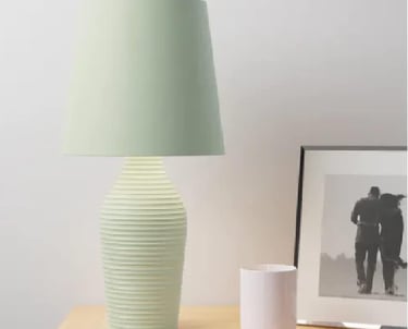 a table lamp with a green lamp shade on it