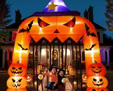 a couple of kids standing in front of a halloween themed archway