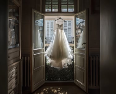 a wedding dress hanging in a doorway