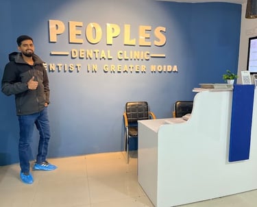 A dental patient at Peoples Dental Clinic showing a Thumbs up and recommending the dentist