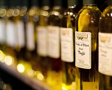 Bottles of olive oil for tasting at a shop in Ojai, California with warm golden lighting