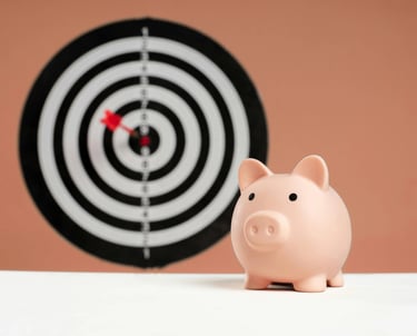 Piggy bank next to a bullseye dart symbolizing finding the best mortgage rates