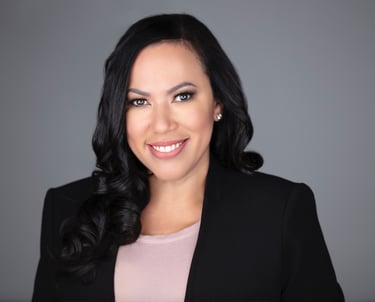 a woman in a black suit and pink top