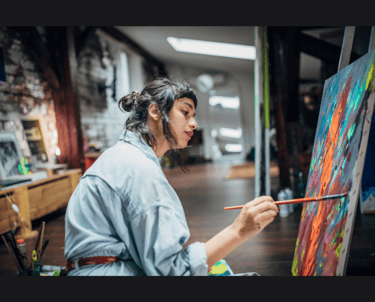 A female artist working on a painting