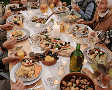 A group dinner with the image focused mostly on the plates of food