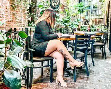 Business owner sitting at a table reading a book
