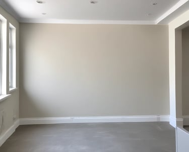 A professional painter applying fresh paint to a residential home.