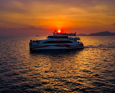 Lomprayah high-speed ferry carrying passengers across the ocean during a vibrant orange sunset in Thailand.