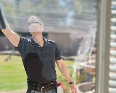 man washing a home window
