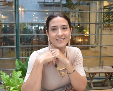 a woman sitting at a table with a laptop