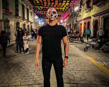 A bald man with half his face painted in Oaxaca