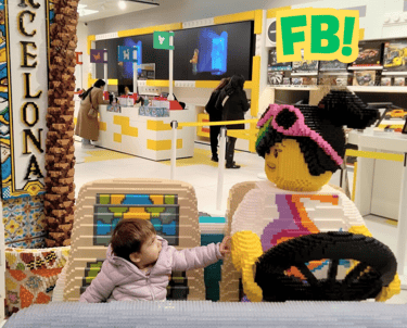 a baby in a toy car in a store