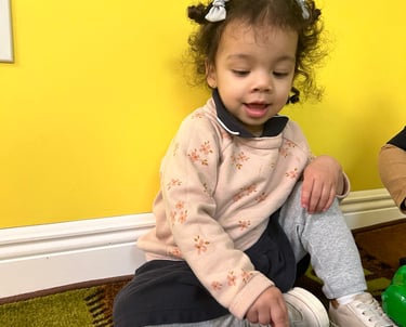 a young girl sitting on the floor with a toy-FANTASTIC LAND LEARNING CENTER
