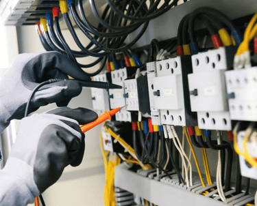 an electrician at work in an industrial warehouse
