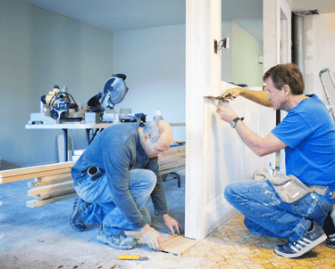 a couple of men are working on a hotel room remodeling project