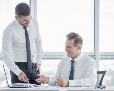 Consultant and client reviewing documents in an office Saudi Food Registration