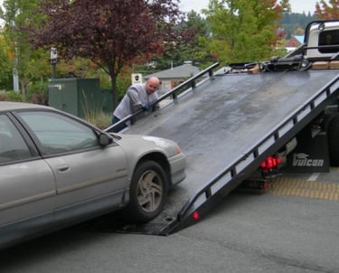 a car being towed by a tow truck