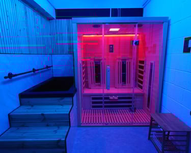 An infrared sauna and cold plunge with blue relaxing lighting