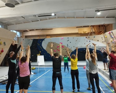 a group of people exercising in a climbing gym