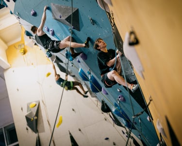 a man lead climbing on a climbing wall