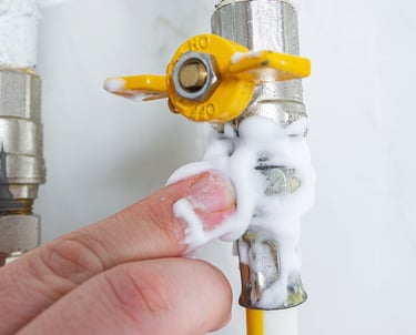 a person holding a pipe of soap and a pipe of soap