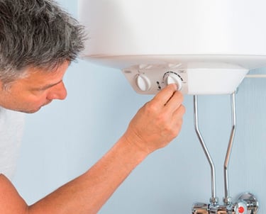 a man is looking at a water heater