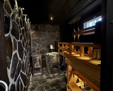 Rustic sauna, with slate masonery, and wide plank benches, iki kiuas