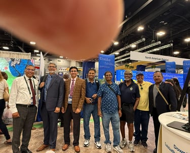 a group of people standing around a table