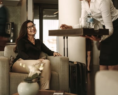 Woman being served water at airport lounge