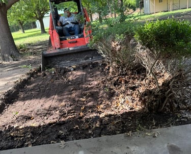 a man is driving a skidsteer in the dirt