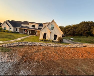 a farrm house with a stone drainage landscape