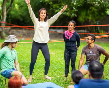 a woman learning to slackline with the YogaSlackers