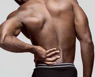 Male with hand on his back showcasing chronic pack pain
