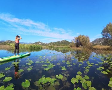girl on paddle board on lake skadar