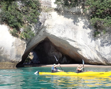 two travellers kayaking in cathedral cove