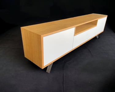 a modern entertainment center with a white cabinet and a wooden entertainment center