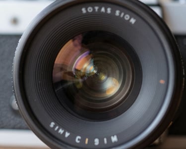 A vibrant behind-the-scenes shot of a film crew capturing an energetic outdoor challenge event.