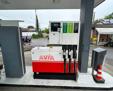 An Avia gas station fuel pump with unleaded and diesel dispensers under a canopy.