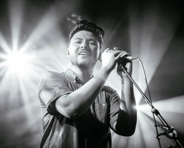 a man in a shirt is holding a microphone