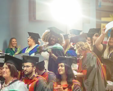 a group of people in graduation gowns and caps