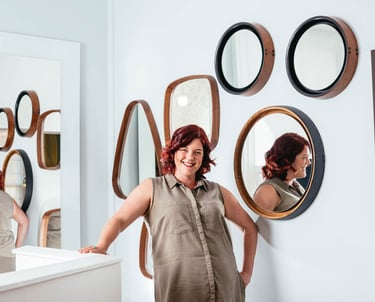 a woman standing in front of a mirror