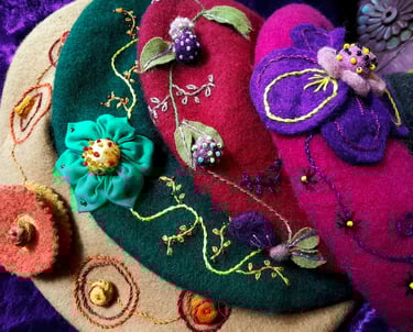 a group of colorful felt hats with flowers