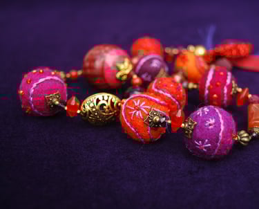 a bunch of beads and beads on a purple background
