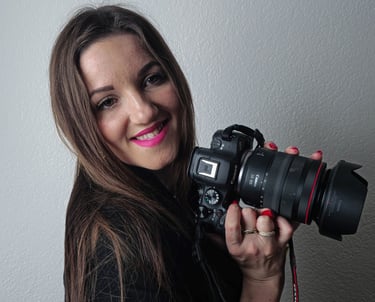 me holding a camera and smiling