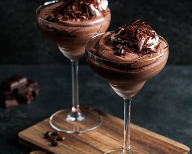 two glasses of chocolate mousse with whipped cream