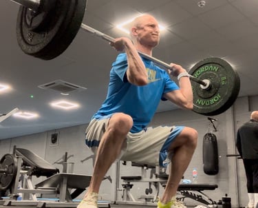 a man is weightlifting in a gym