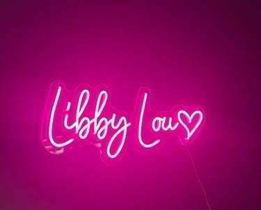 a custom neone sign in pink '