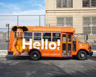 Orange bus wrap with toddler.