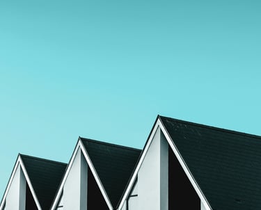 a row of three story houses with black and white siding