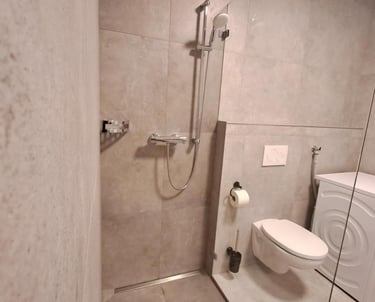 a bathroom with a washing machine and a washing machine